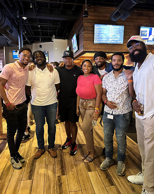 Group of smiling people inside a bar restaurant. 